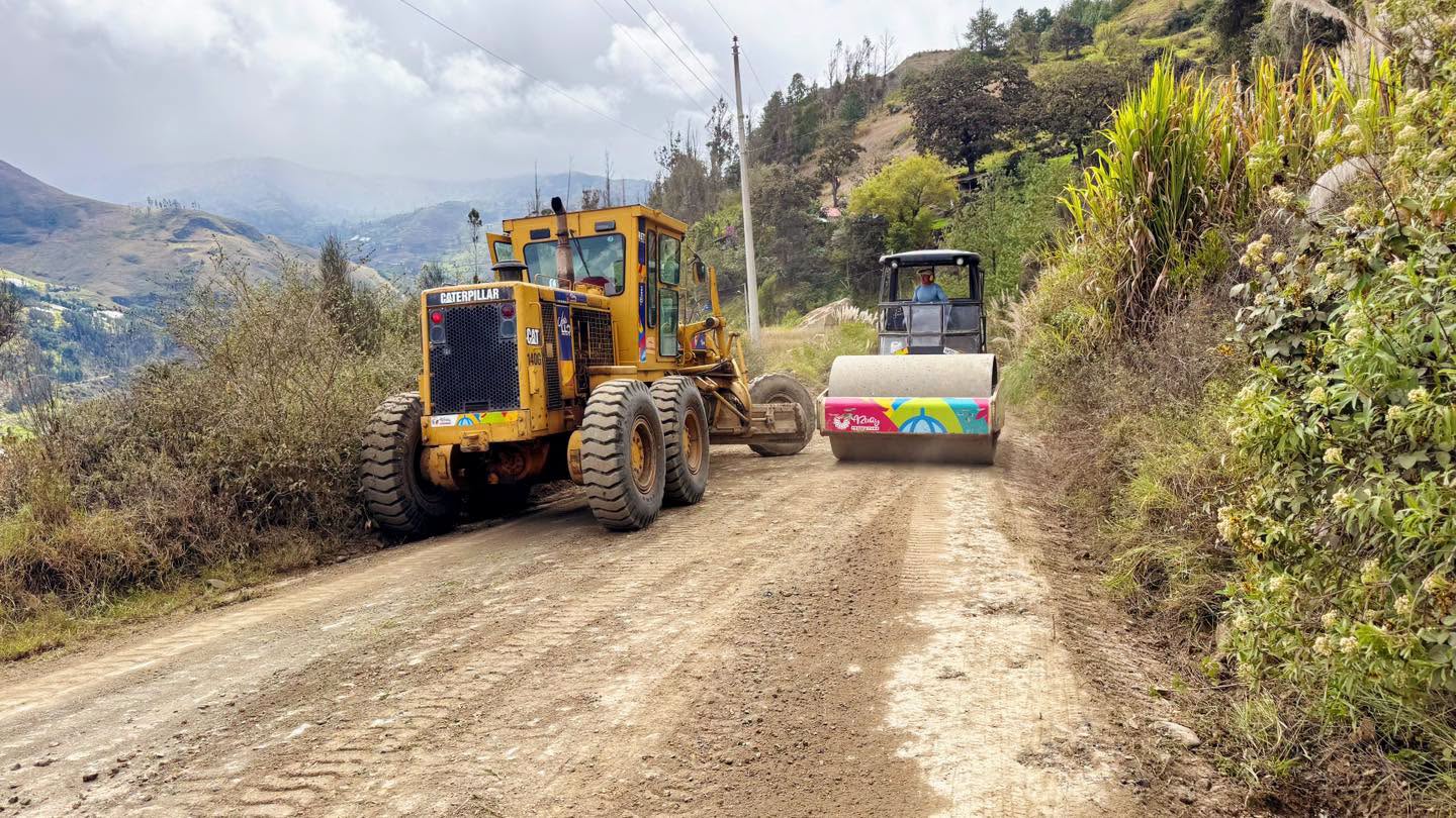 Rodillo compactador y motoniveladora ejecutando trabajos de mantenimiento vial
